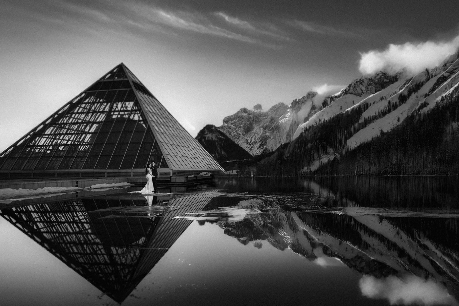 Dramatic black and white architectural wedding photos with mountain reflections.
