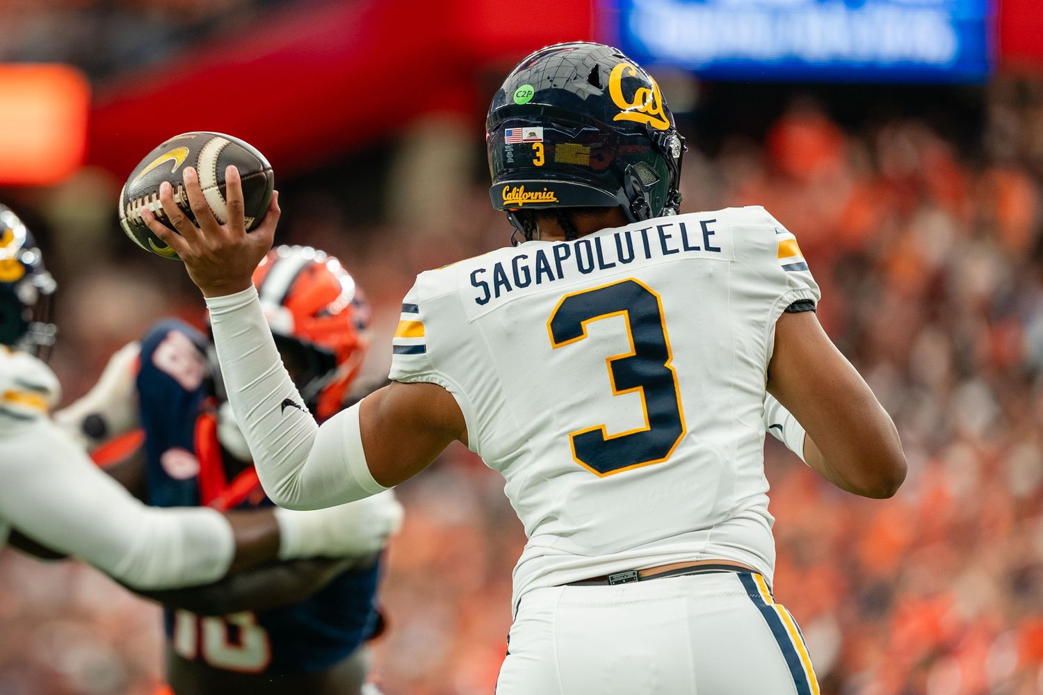 jaron keawe sagapolutele throwing a football in a game against syracuse in the JMA wireless dome jaron keawe sagapolutele