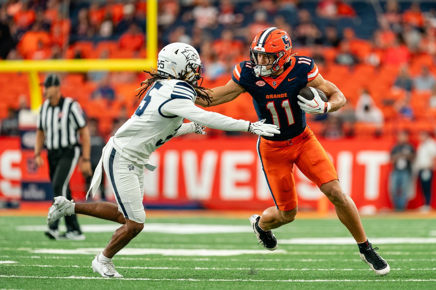 Syracuse football player Cole Weaver stiff arms UNH player against University of New Hampshire on September 5th 2026