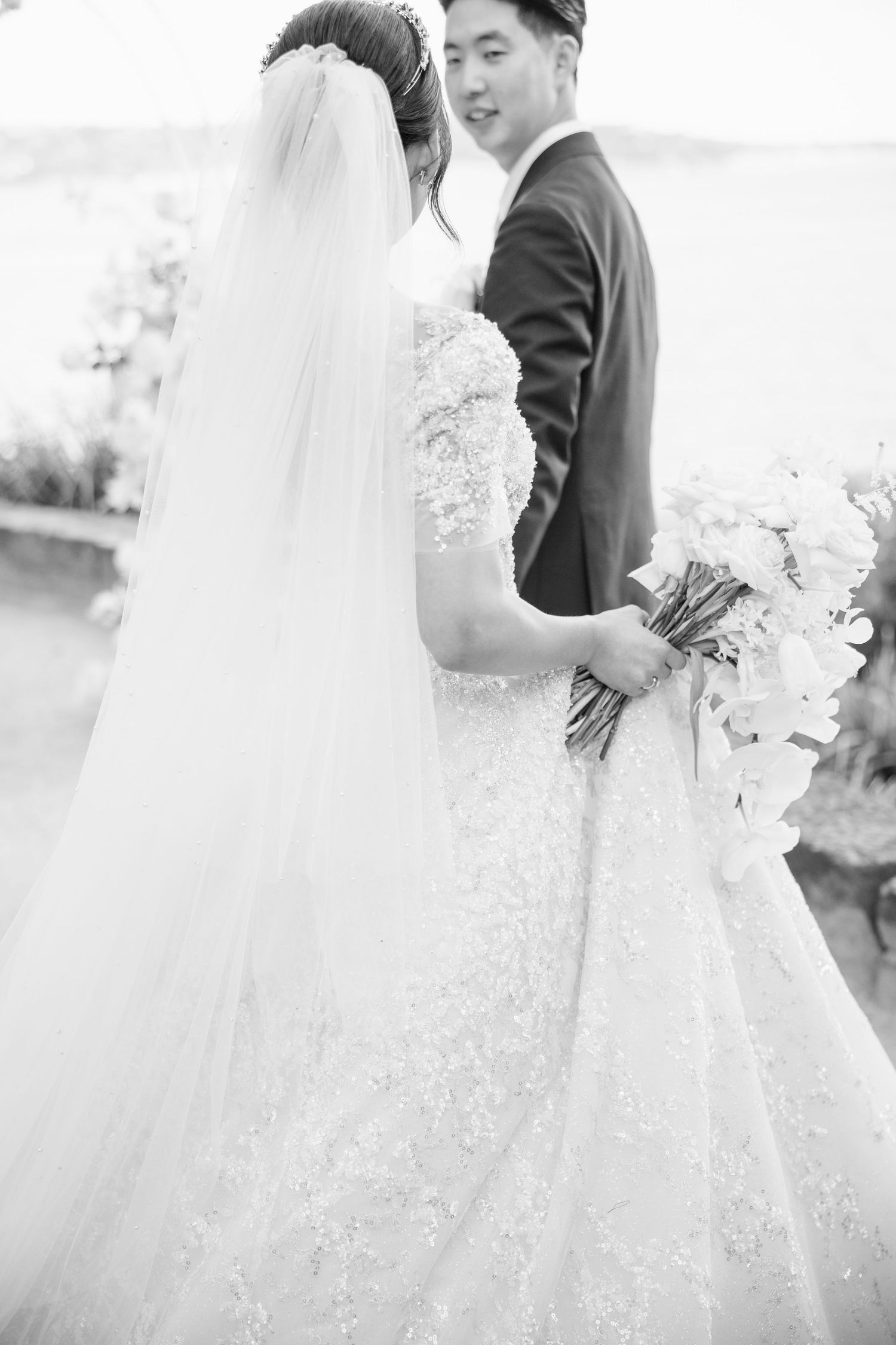 Romantic black and white wedding portraits with flowing veil details.