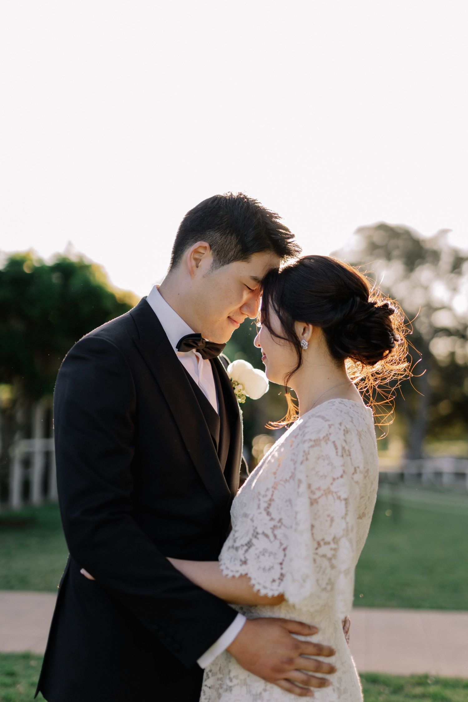 Romantic sunset portraits of couple in formal wedding attire.