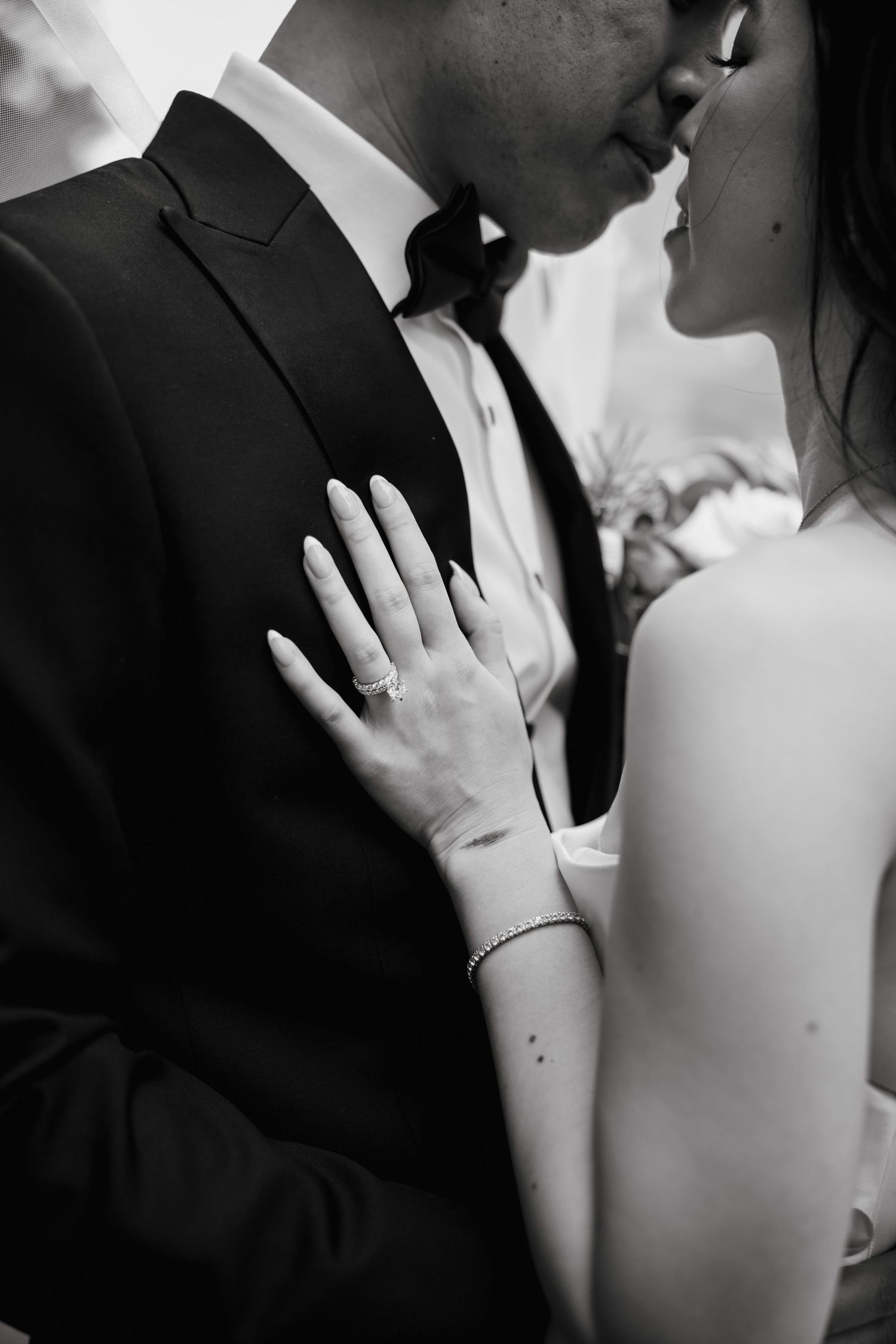 Romantic black and white close-up series showing tender moments between a bride and groom.