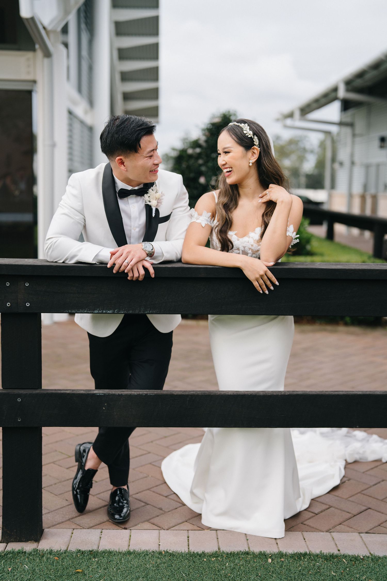 Romantic couple portraits on wooden deck in formal wedding attire.