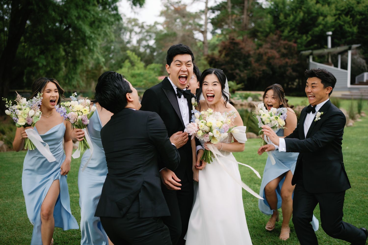 A sequence of candid wedding party photos showing joyful dancing and celebration moments outdoors on a lawn.