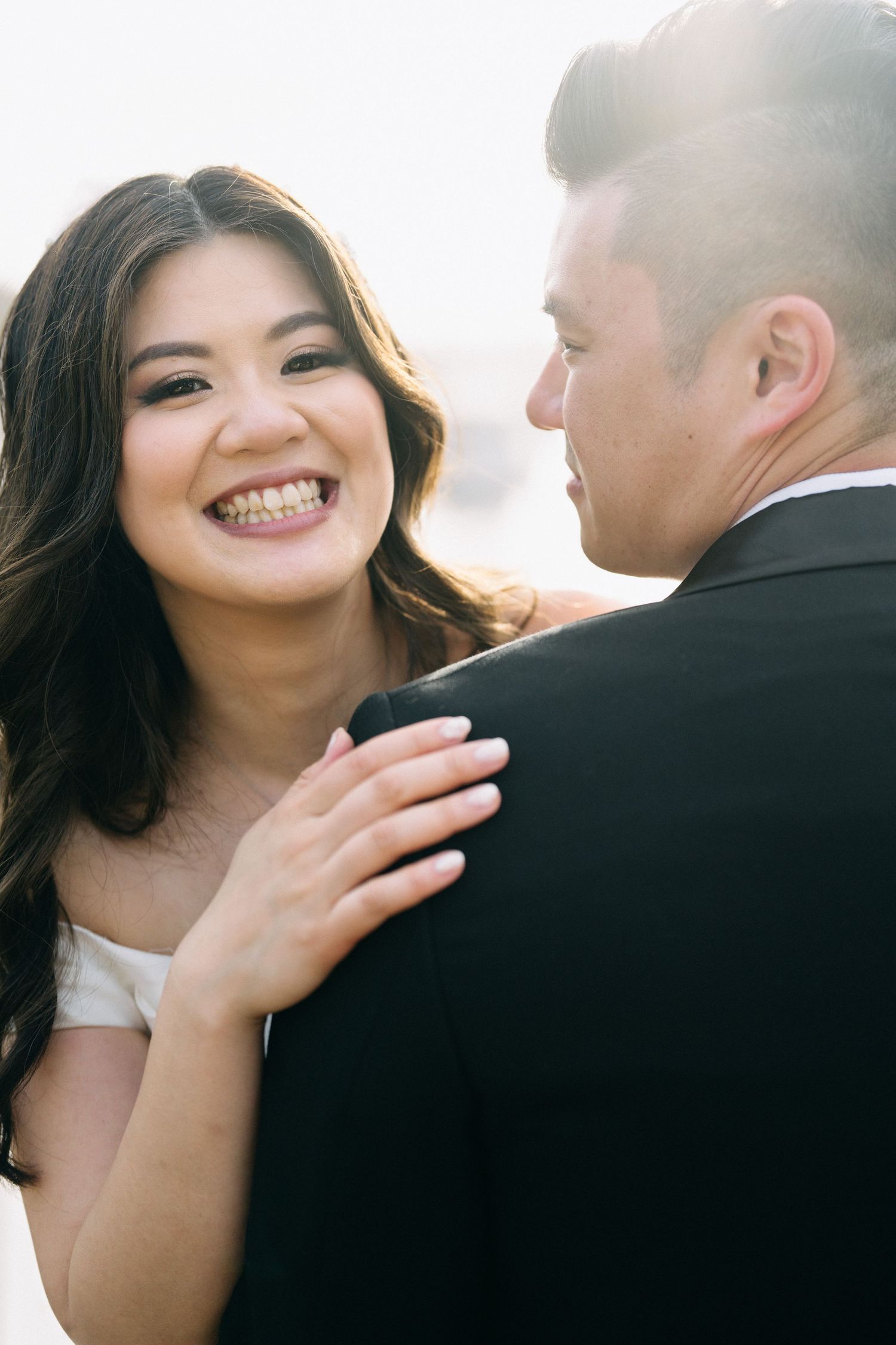 Romantic couple shares joyful moments during outdoor photo session.