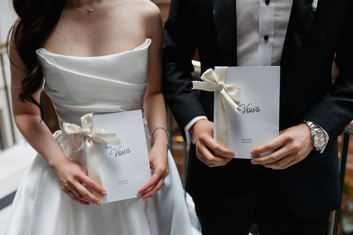 Close-up shots of a white wedding dress being fastened with buttons and ribbons.