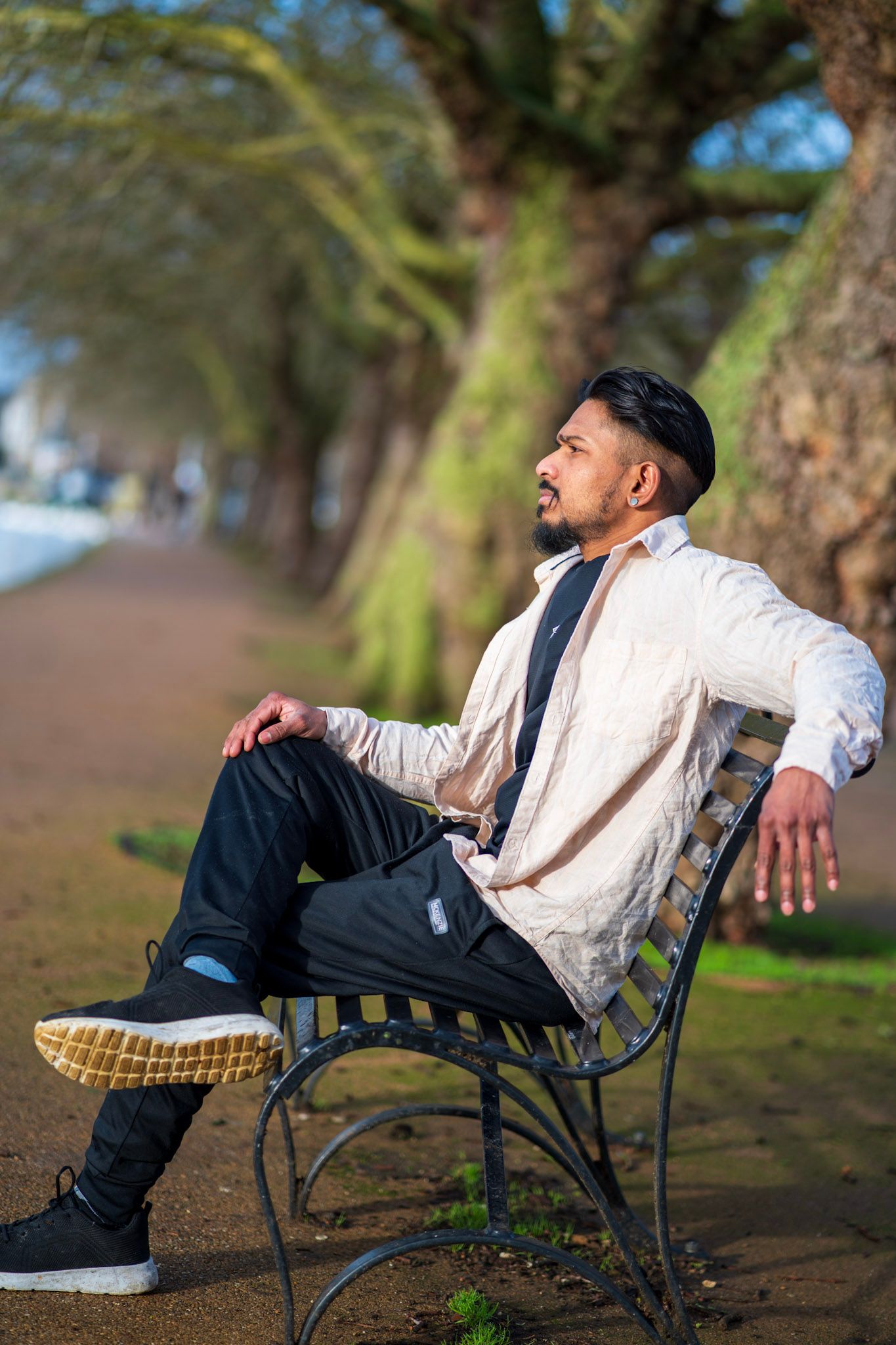 A young man gazing side ways on a embankment