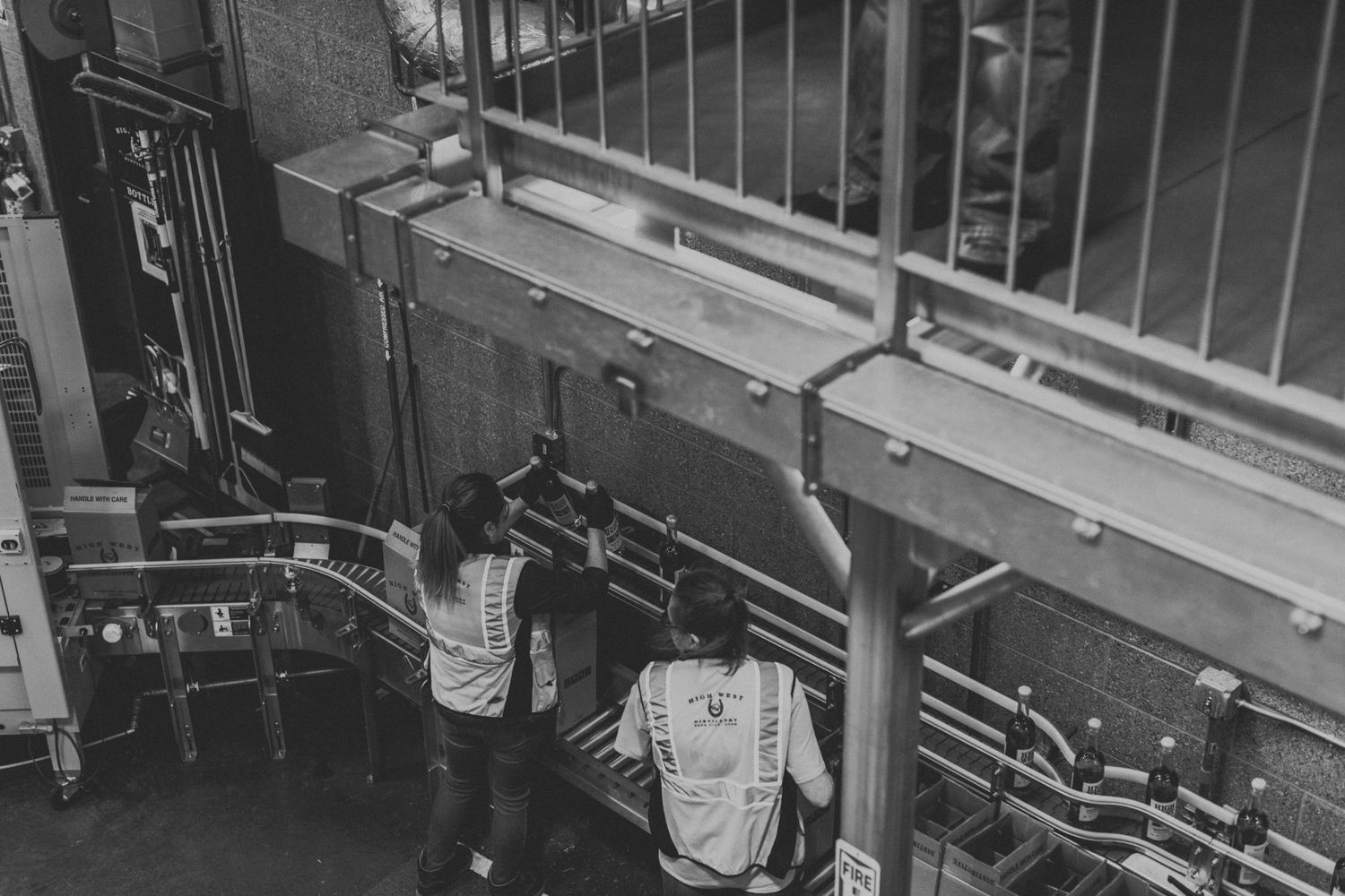 Industrial distillery equipment and machinery shown in a monochrome photograph.