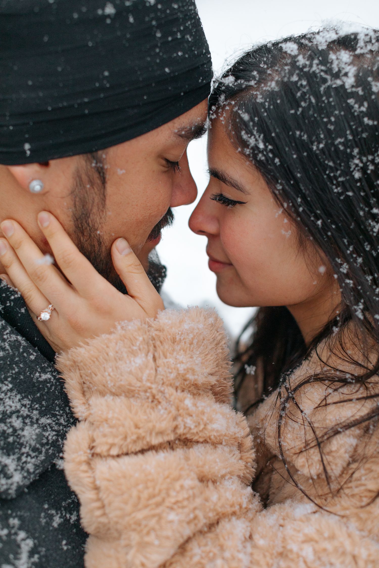 Intimate close-up shots of a couple sharing tender moments in the snow.
