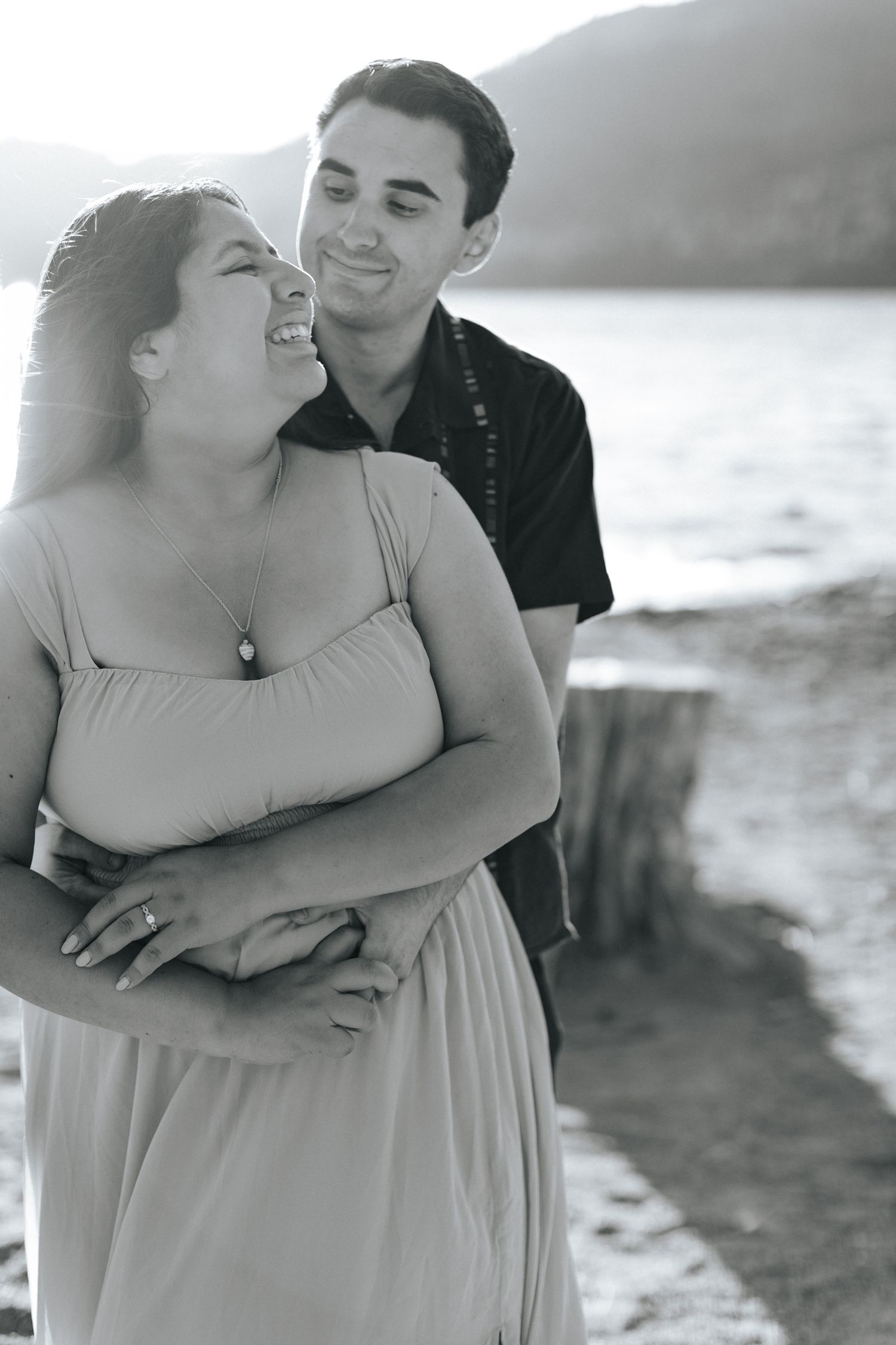 Black and white romantic photoshoot on a beach with soft natural lighting.