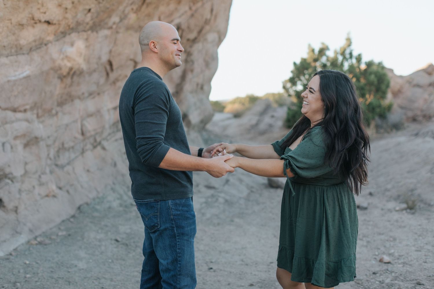 A couple dances together during their desert engagement photo session.