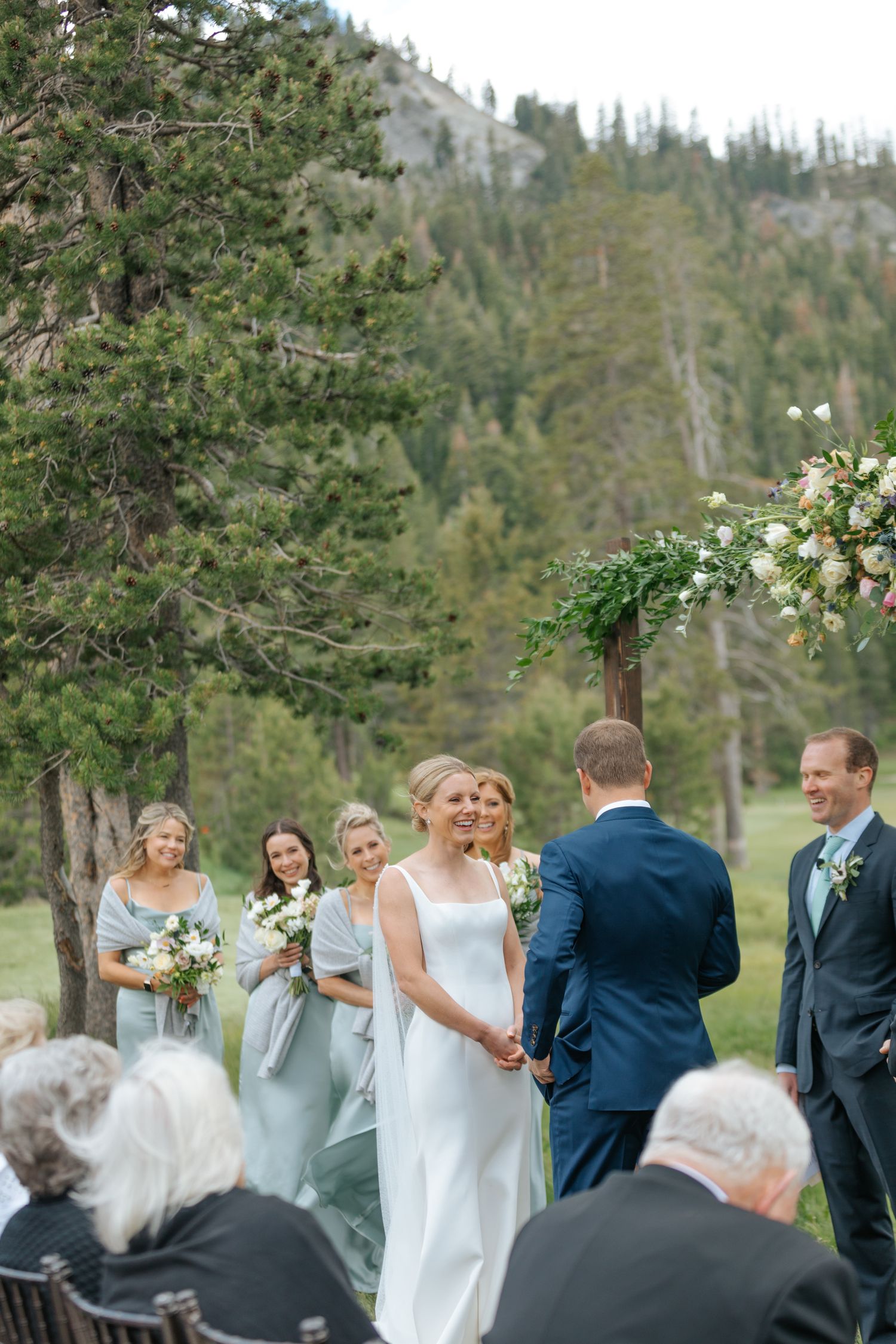 Lake Tahoe wedding bride and groom surrounded by their bridal party as they exchange vows