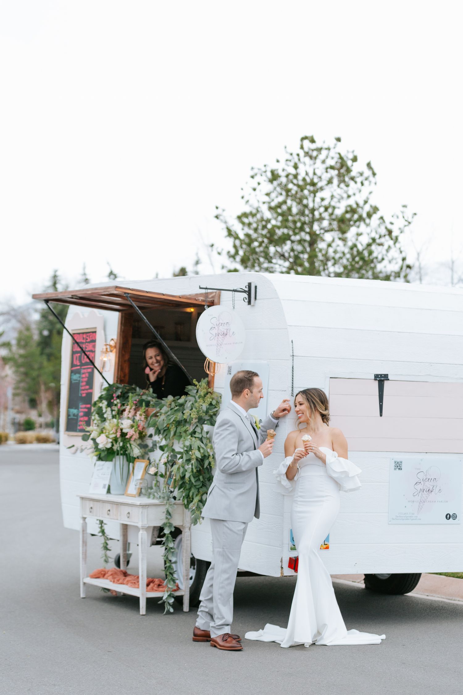 Wedding couple enjoying ice cream treats from white vintage ice cream truck.