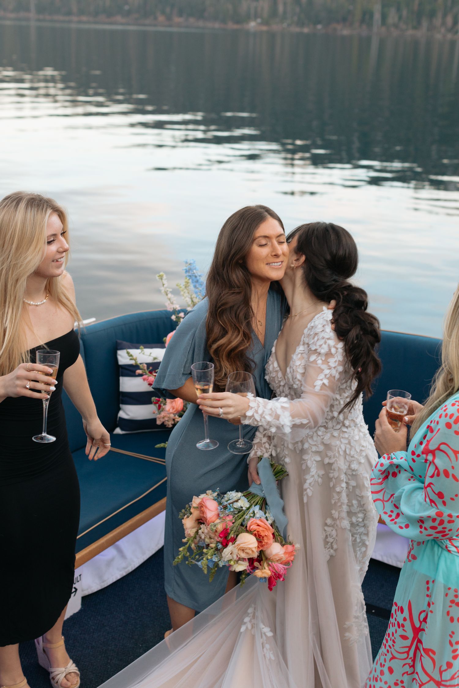 Wedding celebration with guests enjoying drinks on boat deck.