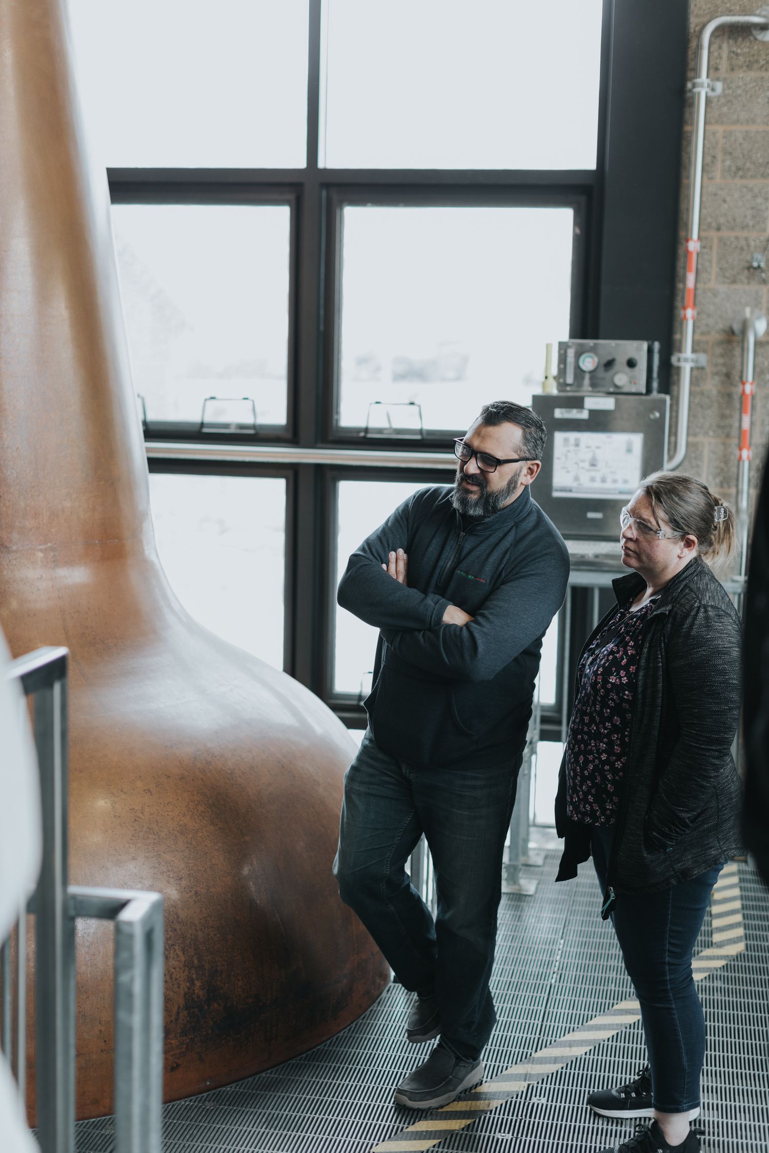 Industrial copper stills photographed from a low angle showing their distinctive shape and design.