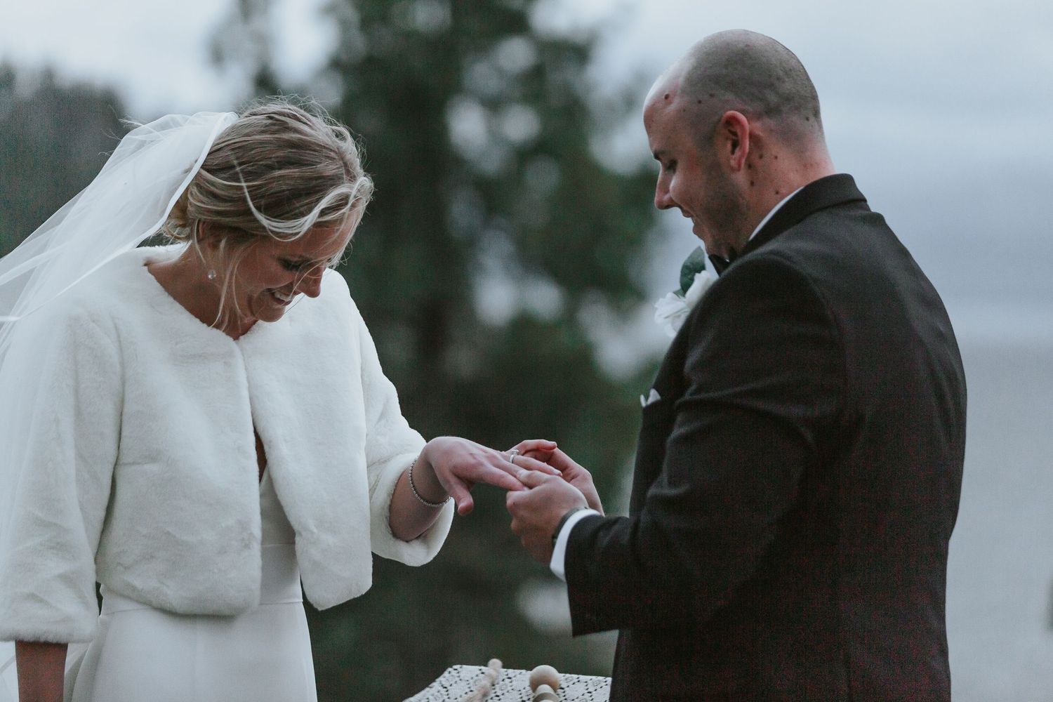 Wedding ceremony exchange of rings in an outdoor setting.