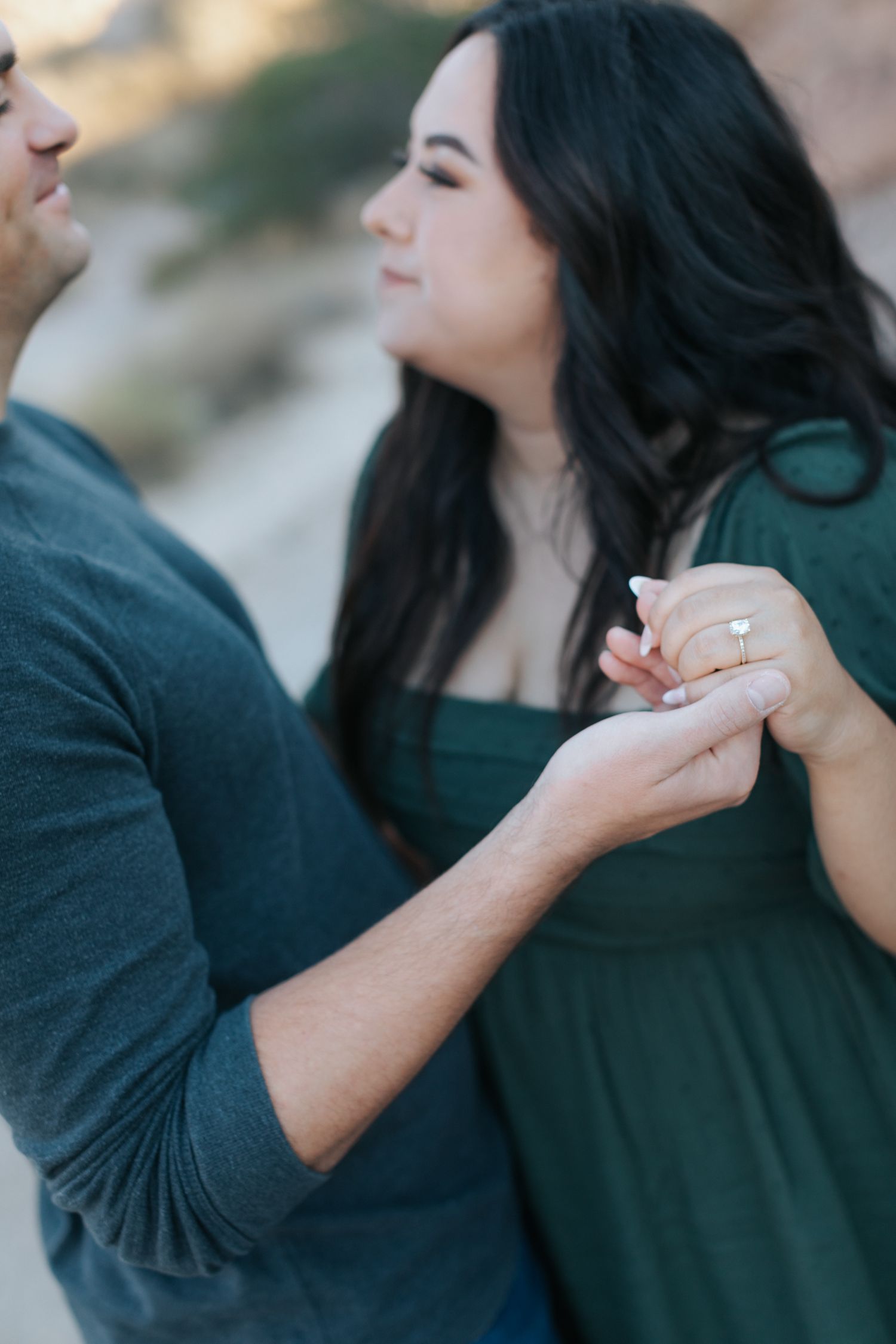 Close-up shots of a couple holding hands during their engagement session.