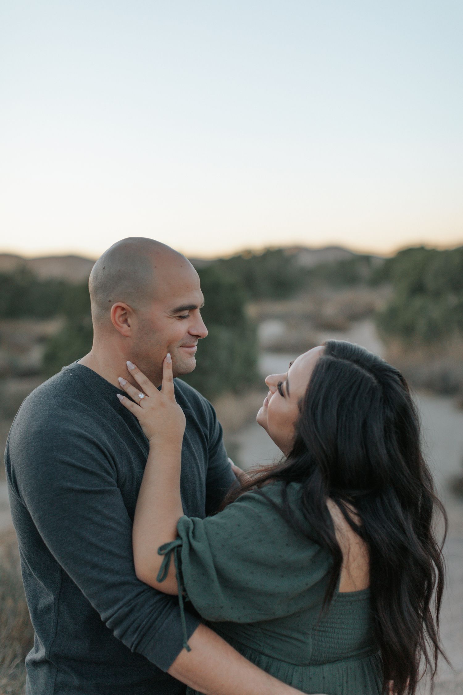 Intimate couple portraits captured against desert scenery during golden hour.