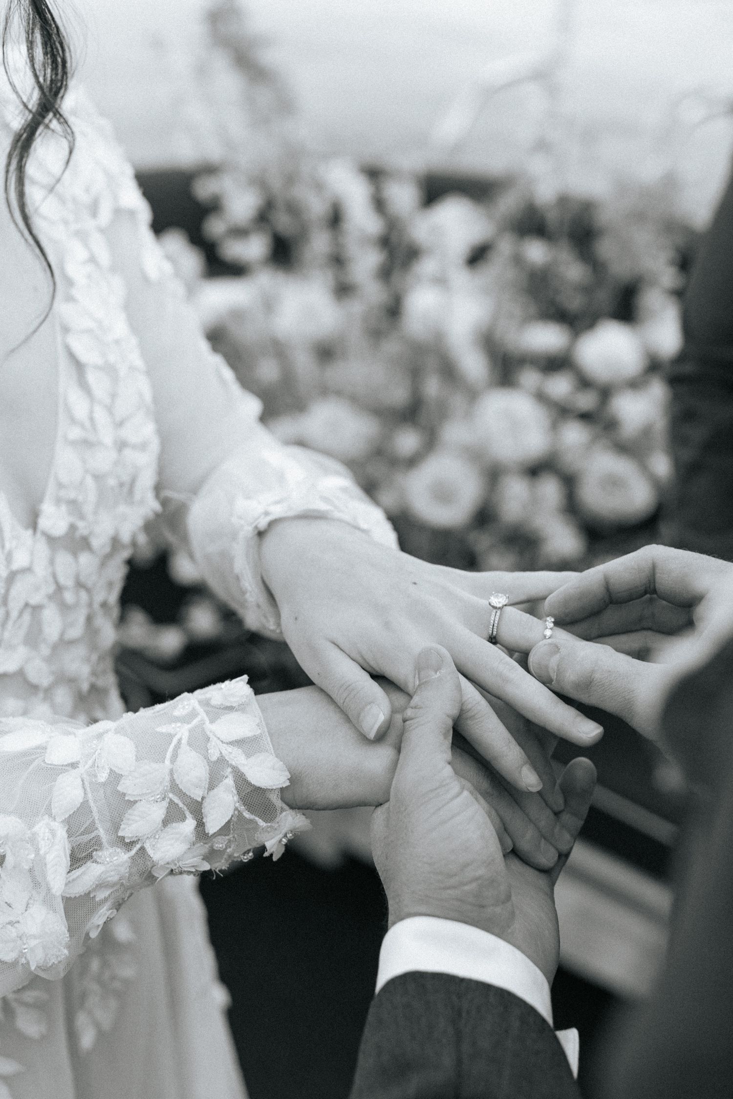 Black and white detail shots of wedding ring exchange ceremony.