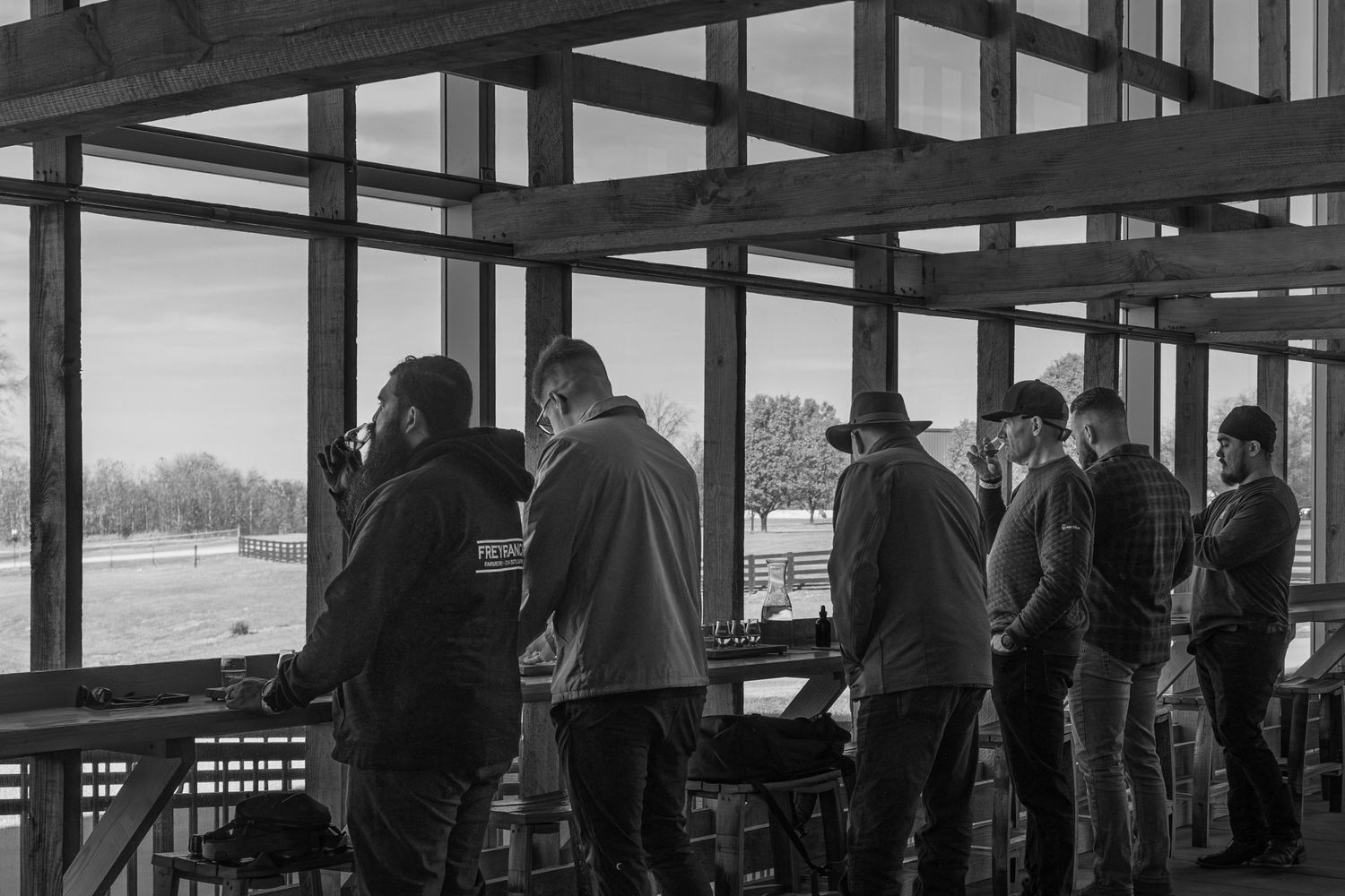 Silhouettes of people at a distillery tasting event.