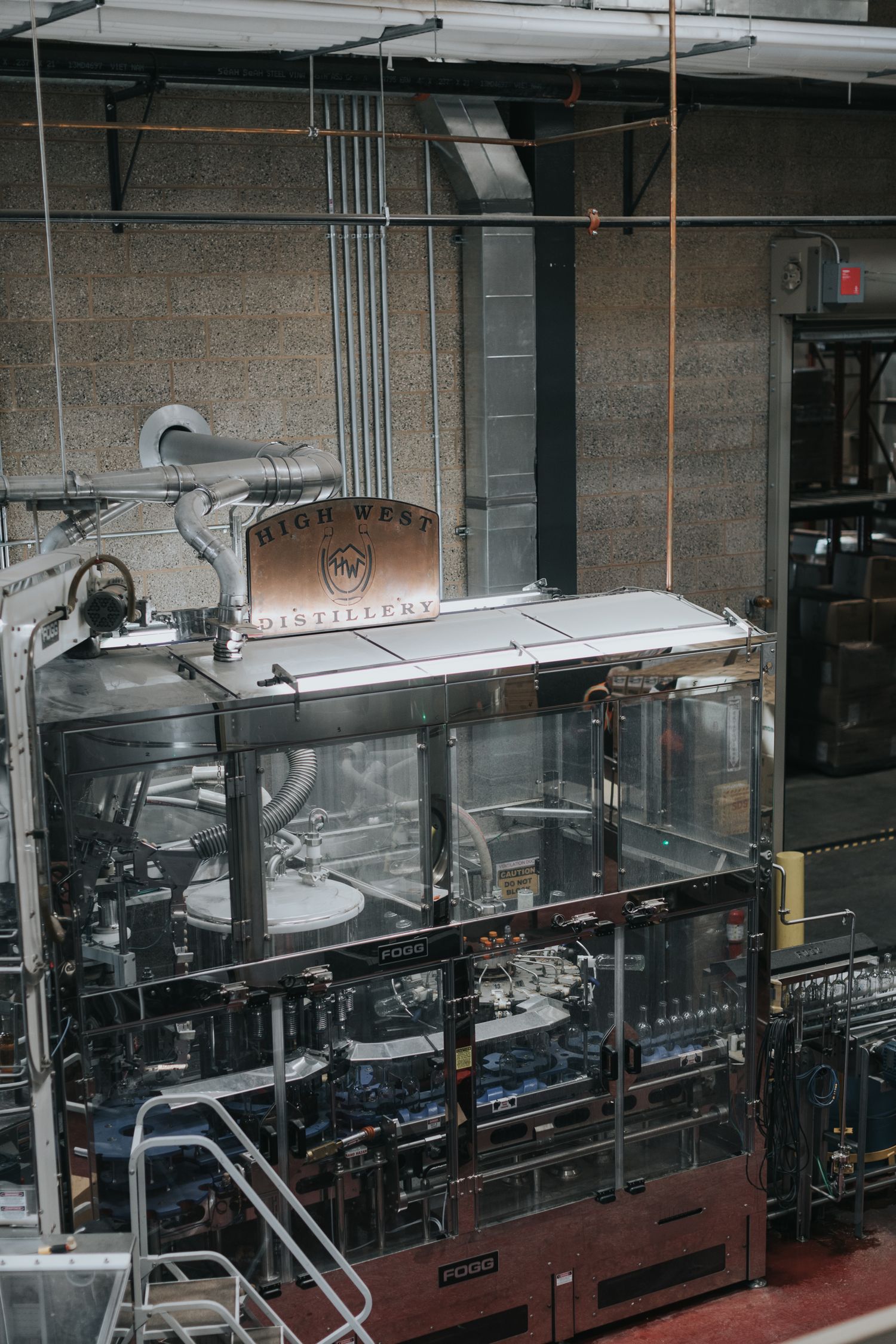 Wide view of industrial bottling line equipment in a modern production facility.