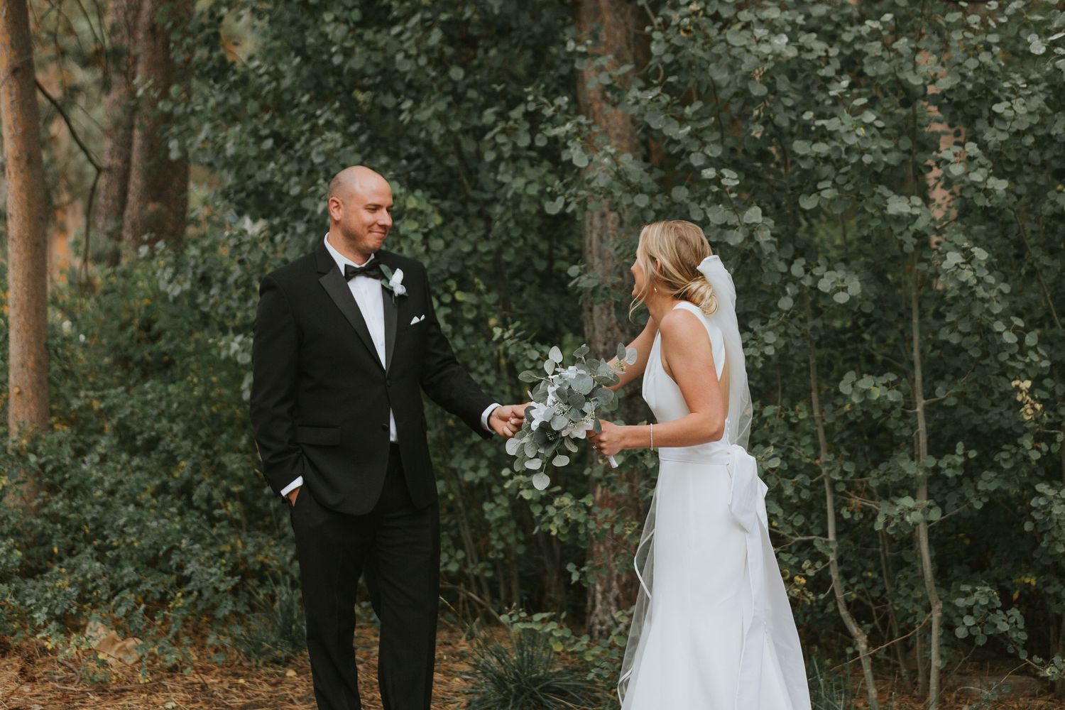 Elegant wedding ceremony taking place in a serene forest setting.