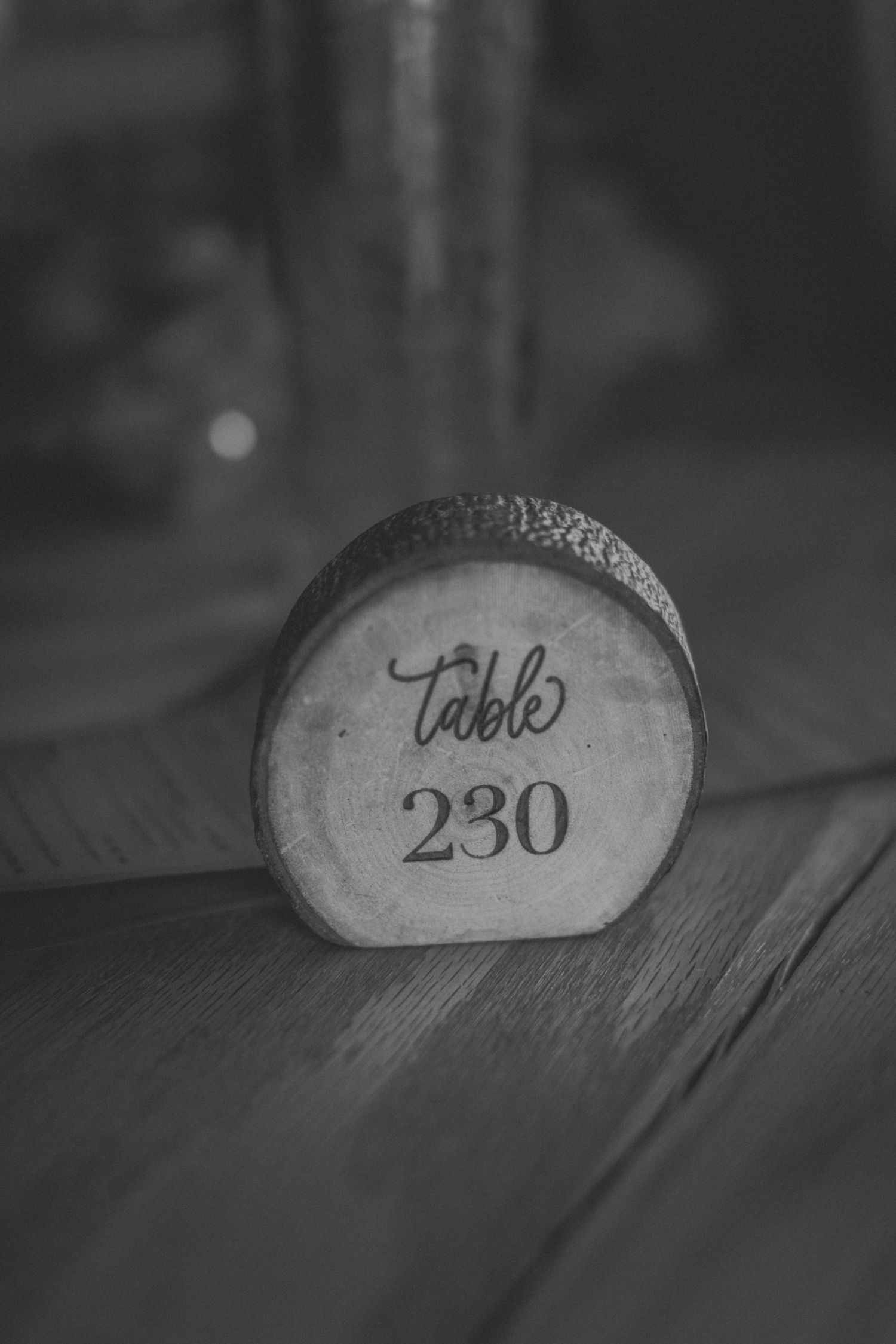 Black and white photograph of numbered wooden barrel markers in a distillery.