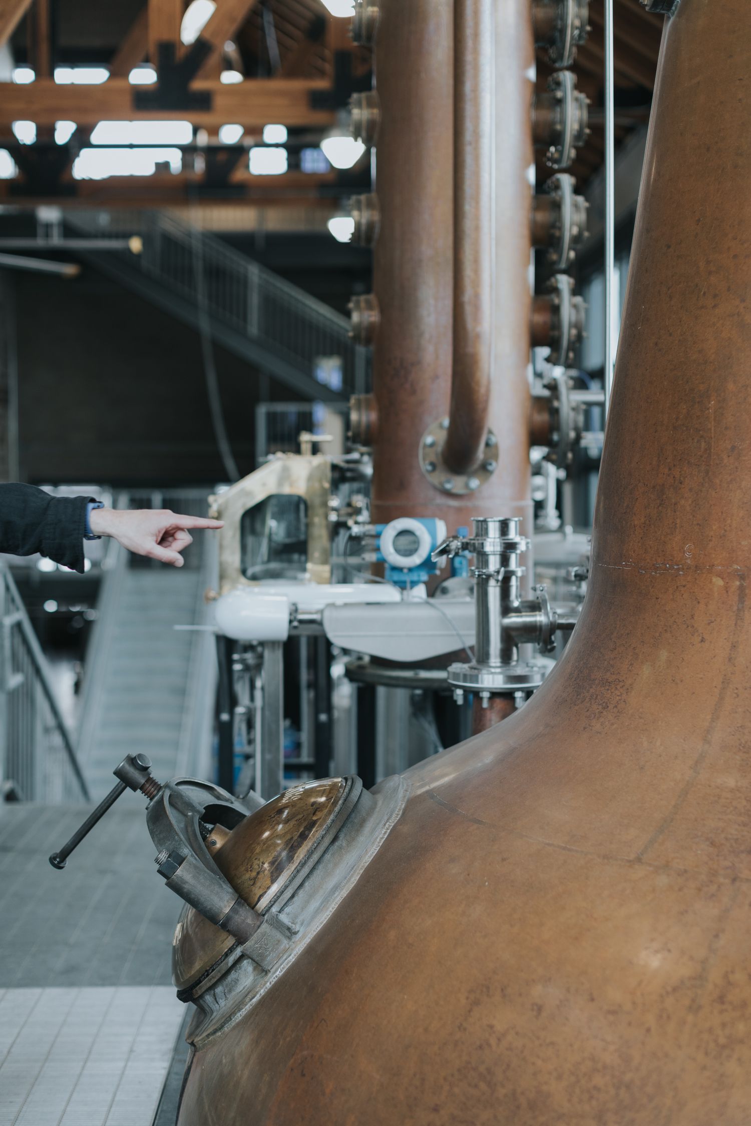 Detail shot of copper still necks with control valves and monitoring equipment.