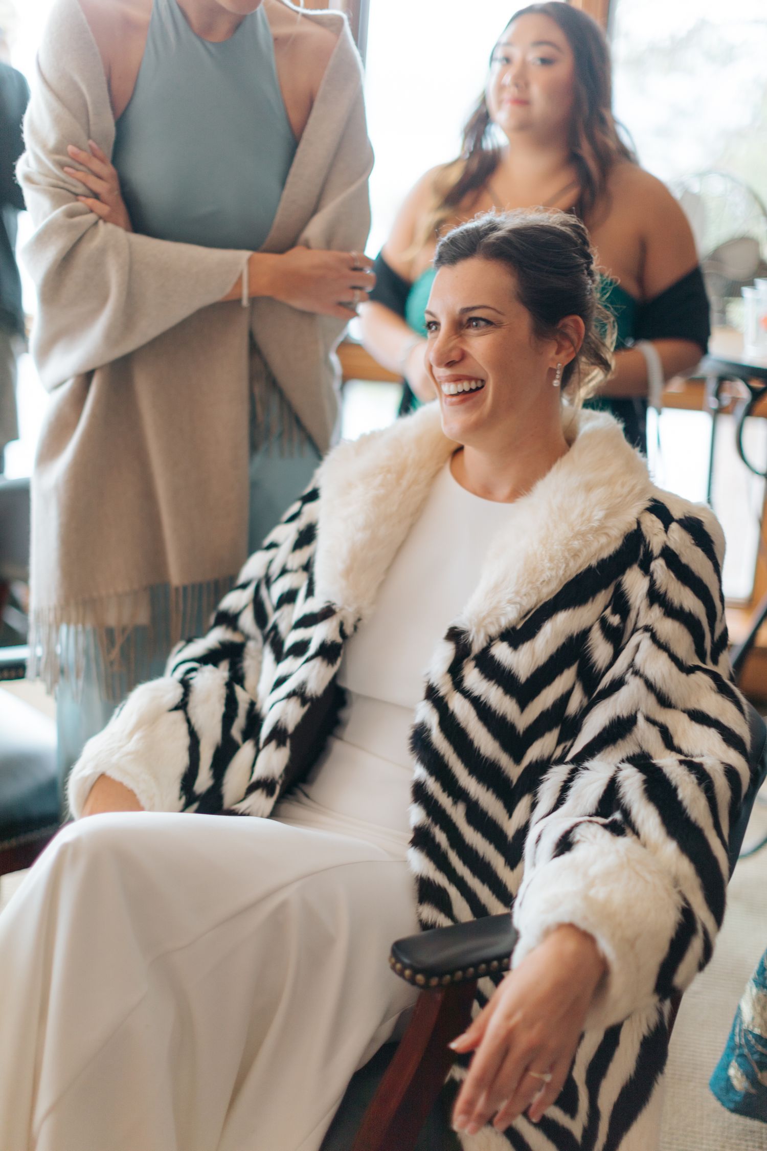 Wedding preparation scene with black and white striped wrap and elegant white attire.