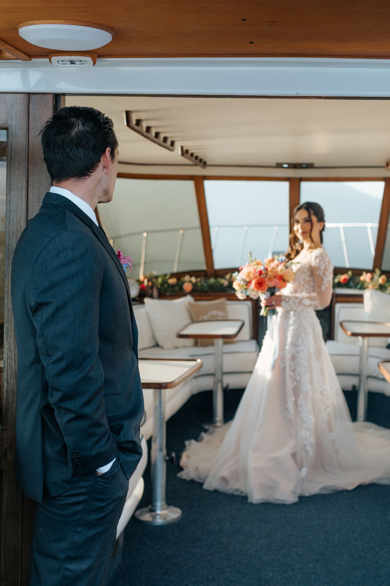 Interior of a luxury yacht cabin with elegant white and wood decor.
