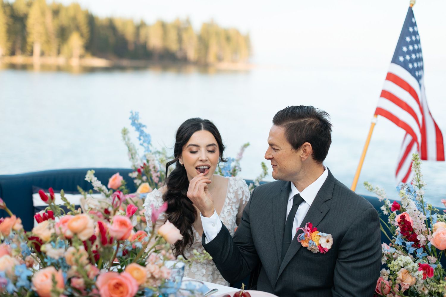 Waterfront wedding celebration with American flag and floral decorations.