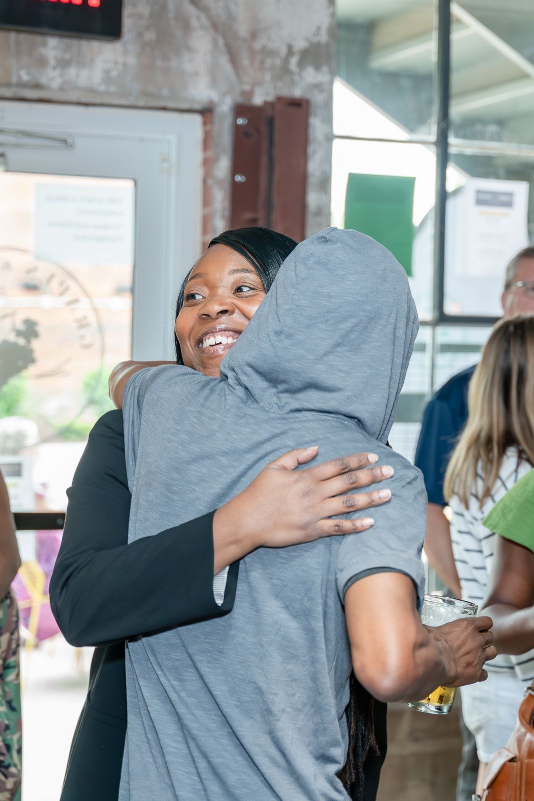 Event photograph of two people hugging.