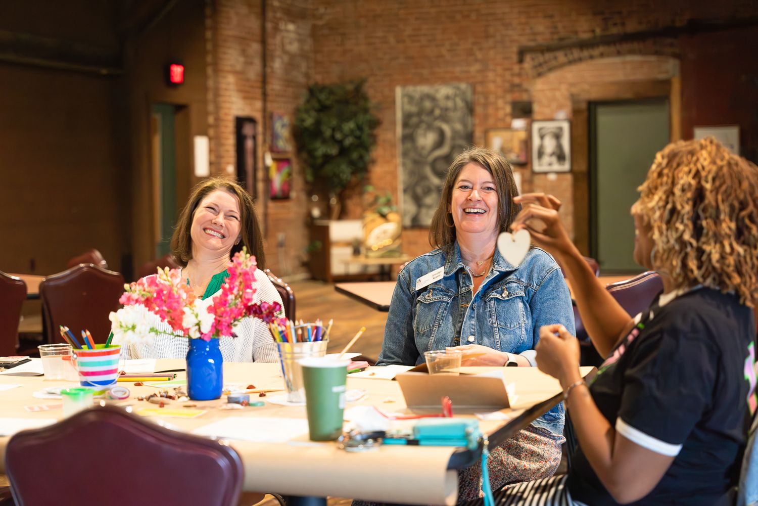 Photograph of women smiling and laughing at an event in High Point, NC.