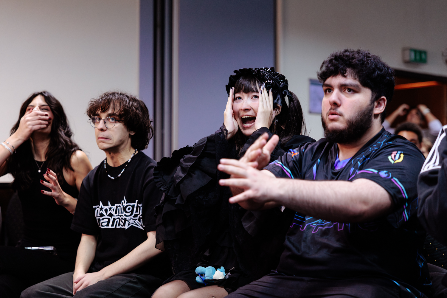 Group of spectators react with excitement while watching a Super Smash Bros. match at the NoTimeToTilt tournament.