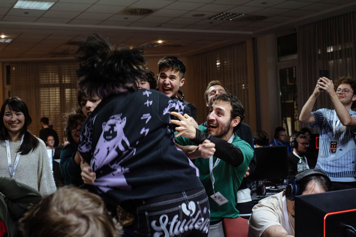 Group of smash players in a tournament room celebrating with raised arms and joyful expressions after a win at No Time To Tilt.