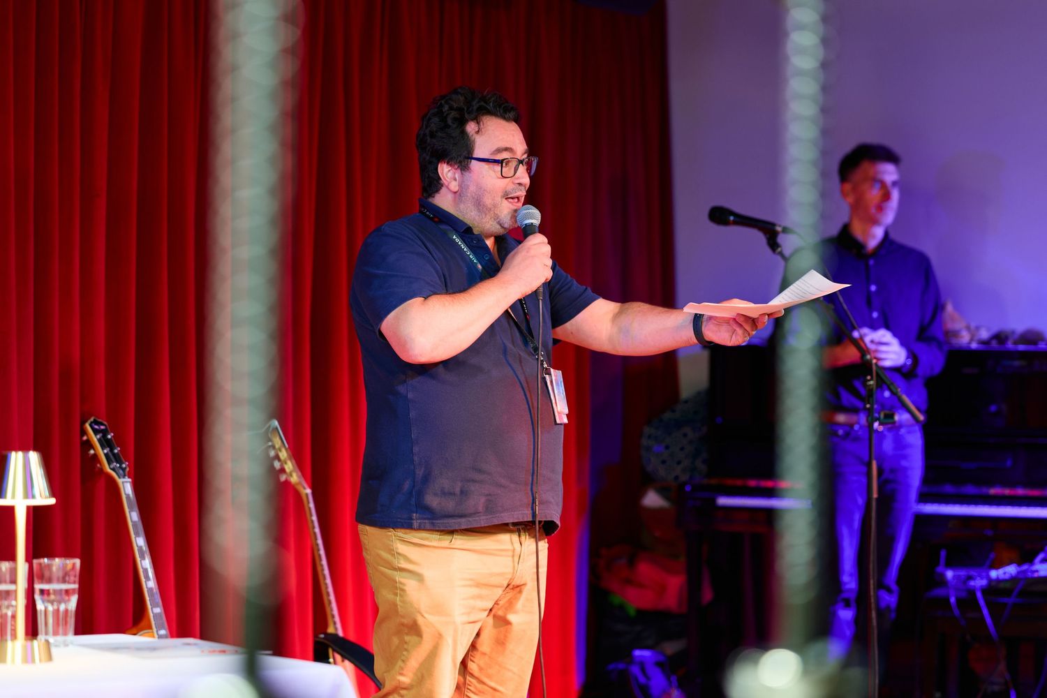 Mehdi Sentissi El Idrissi from Air Canada speaks to guests at the Thanksgiving celebration, holding a microphone and paper.