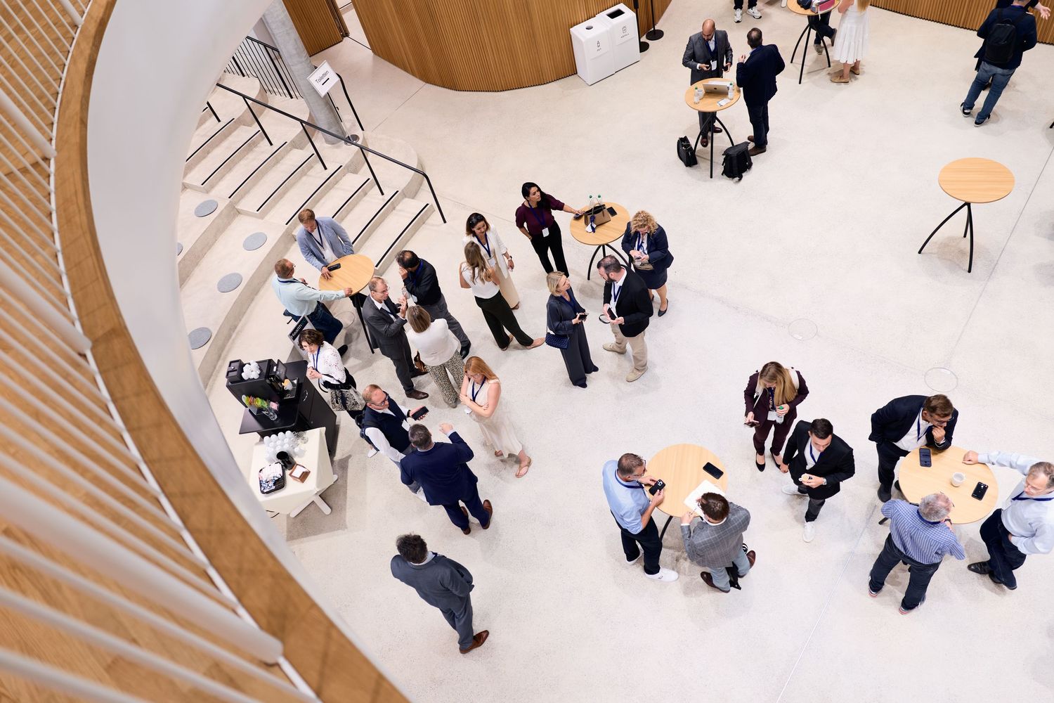 People talking around high tables during a break at the HealthVC Summit at Zurich Children's Hospital.