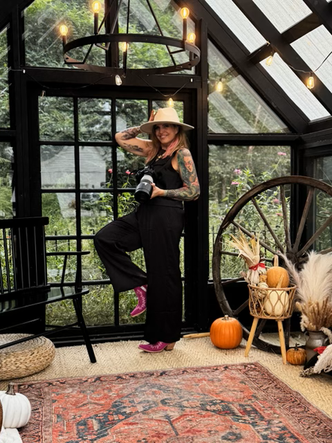 Portrait of photographer Lara inside a styled greenhouse