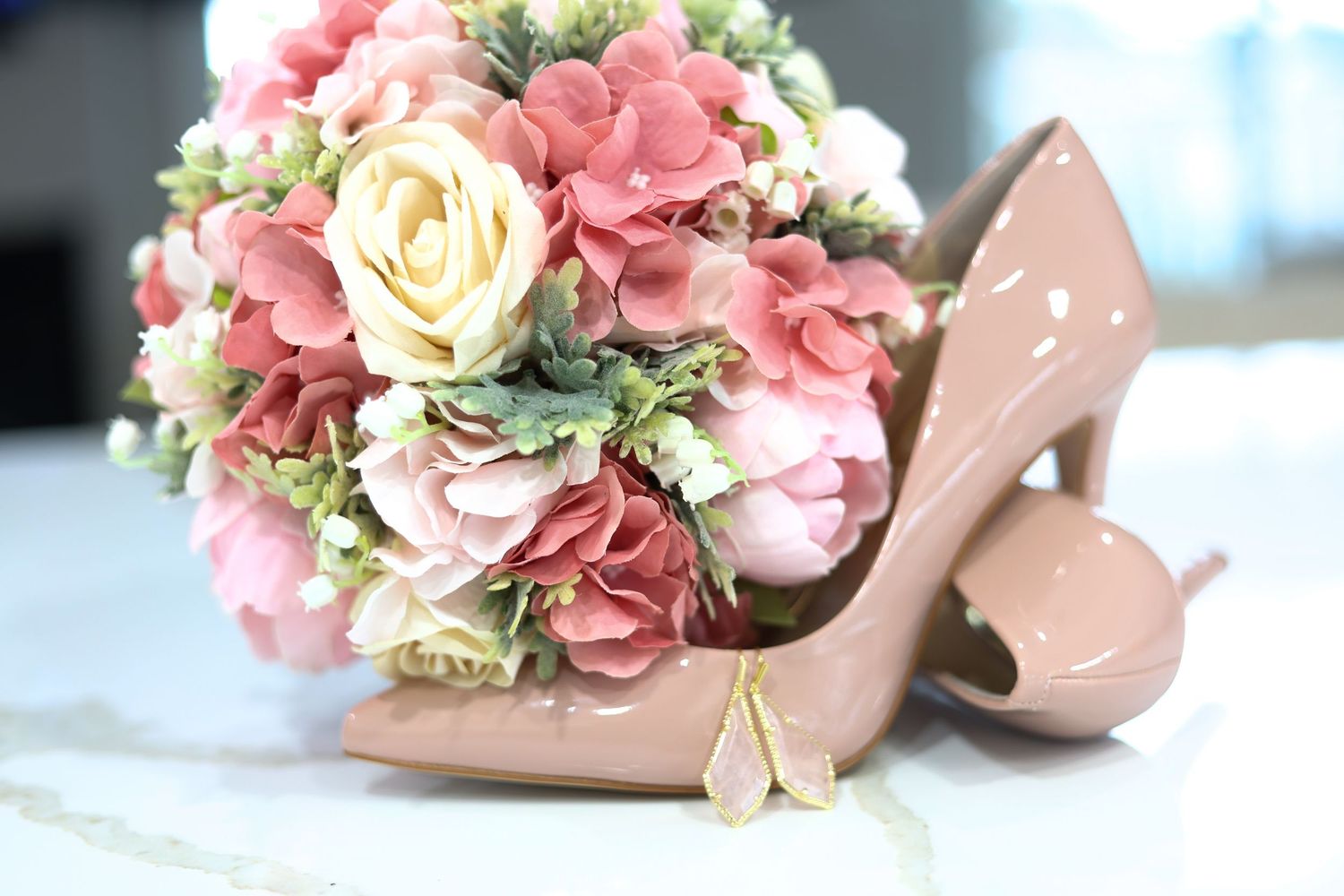 Wedding detail photo of bridal shoes and a floral bouquet