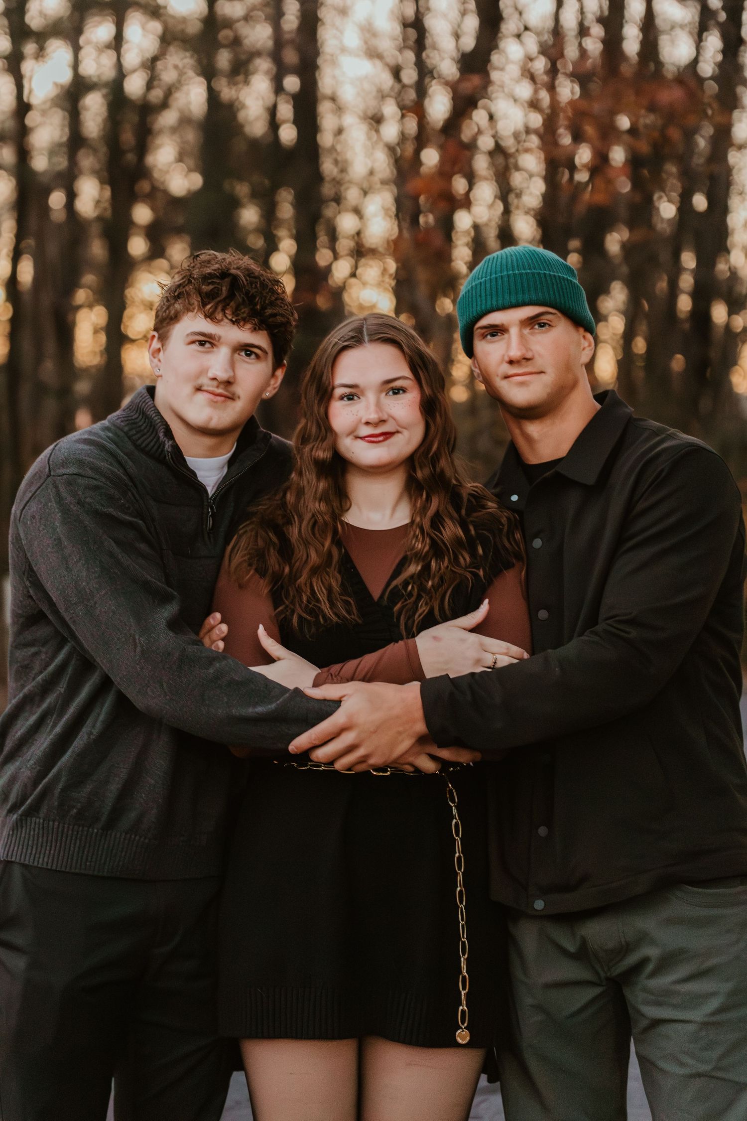 Family portrait of parents with their teenage daughter outdoors