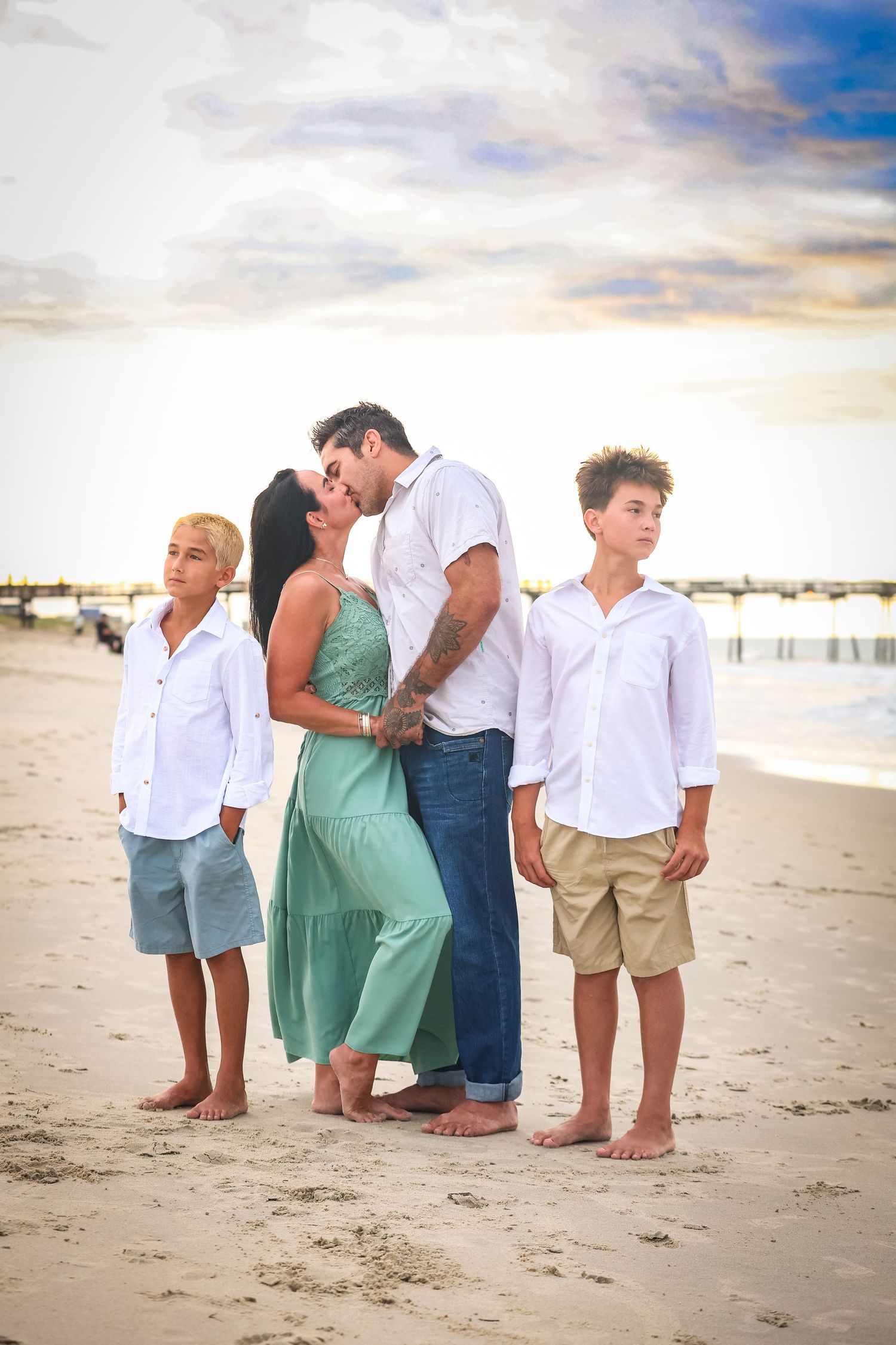 Family portrait standing together on the beach