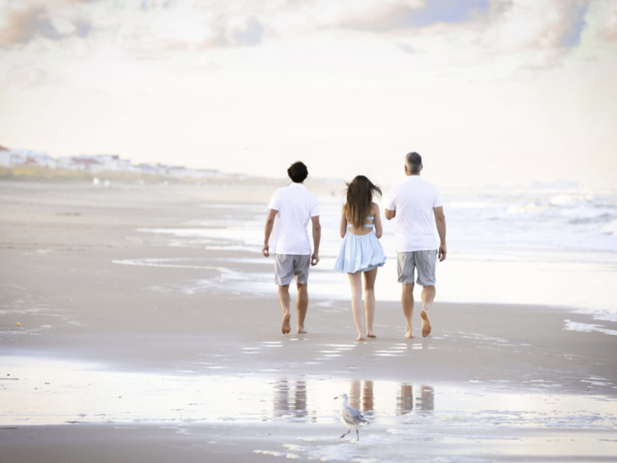Family walking together along the beach