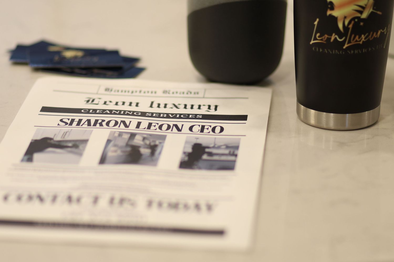 Branding detail photo of printed business materials and a branded tumbler