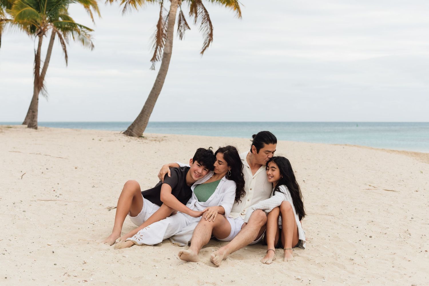 Happy family enjoying a Fiji beach photography session in Fiji on beach