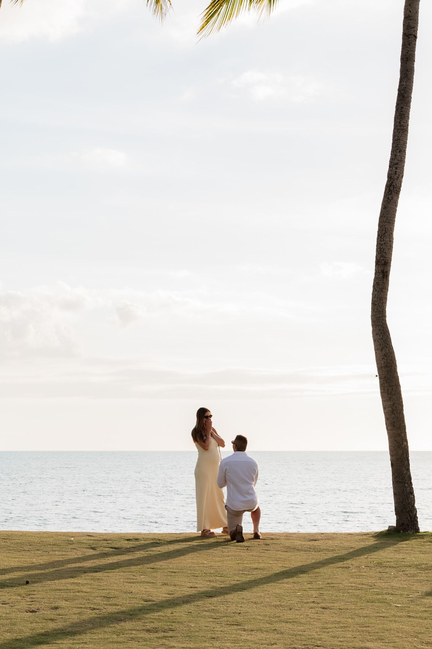Couple celebrating a romantic marriage proposal on a beach in Fiji