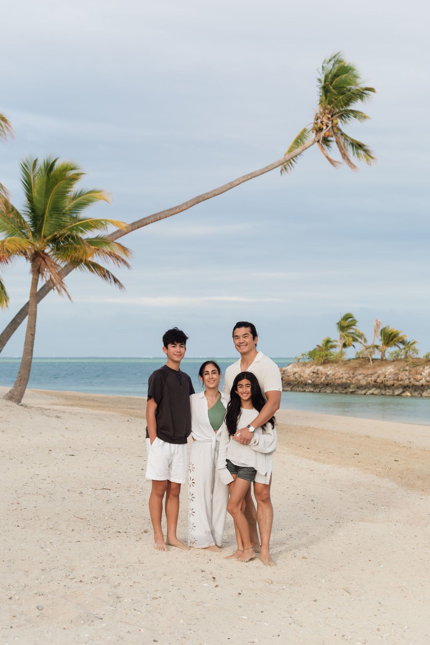 Happy family enjoying a Fiji beach photography session in Fiji on beach