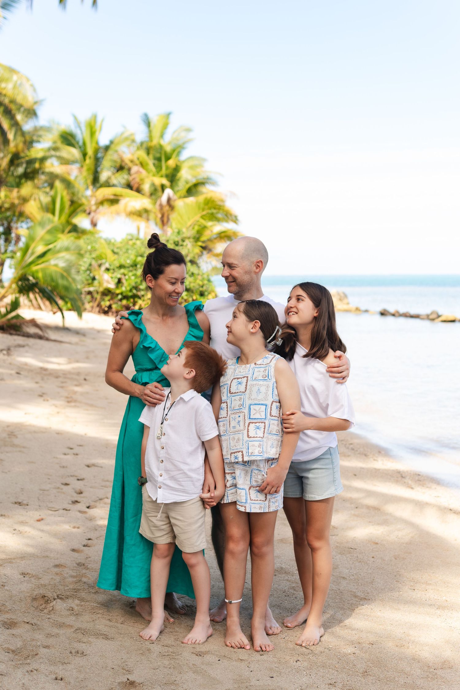 Happy family enjoying a Fiji beach photography session in Fiji on beach