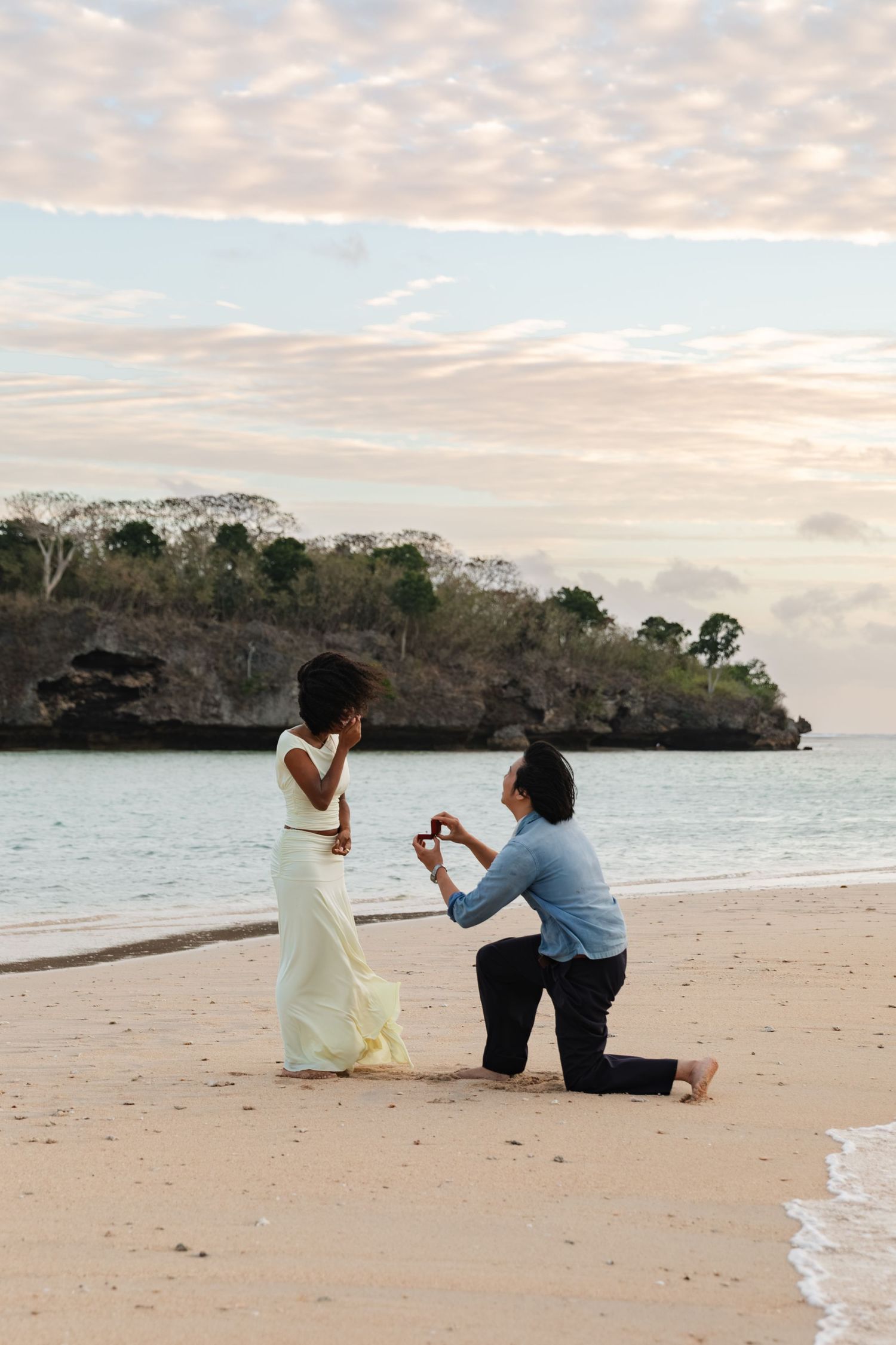Couple celebrating a romantic marriage proposal on a beach in Fiji