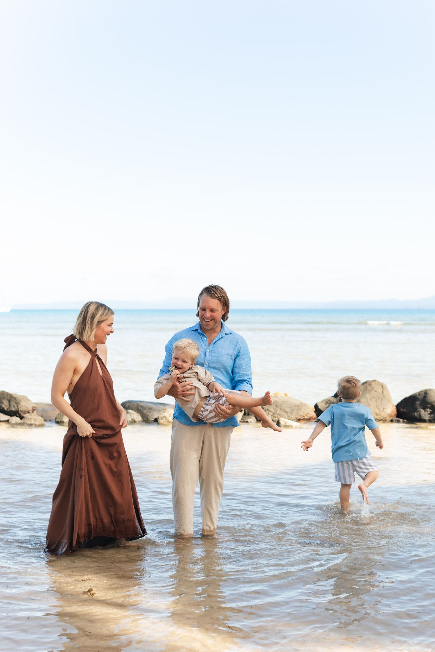 Happy family enjoying a Fiji beach photography session in Fiji on beach