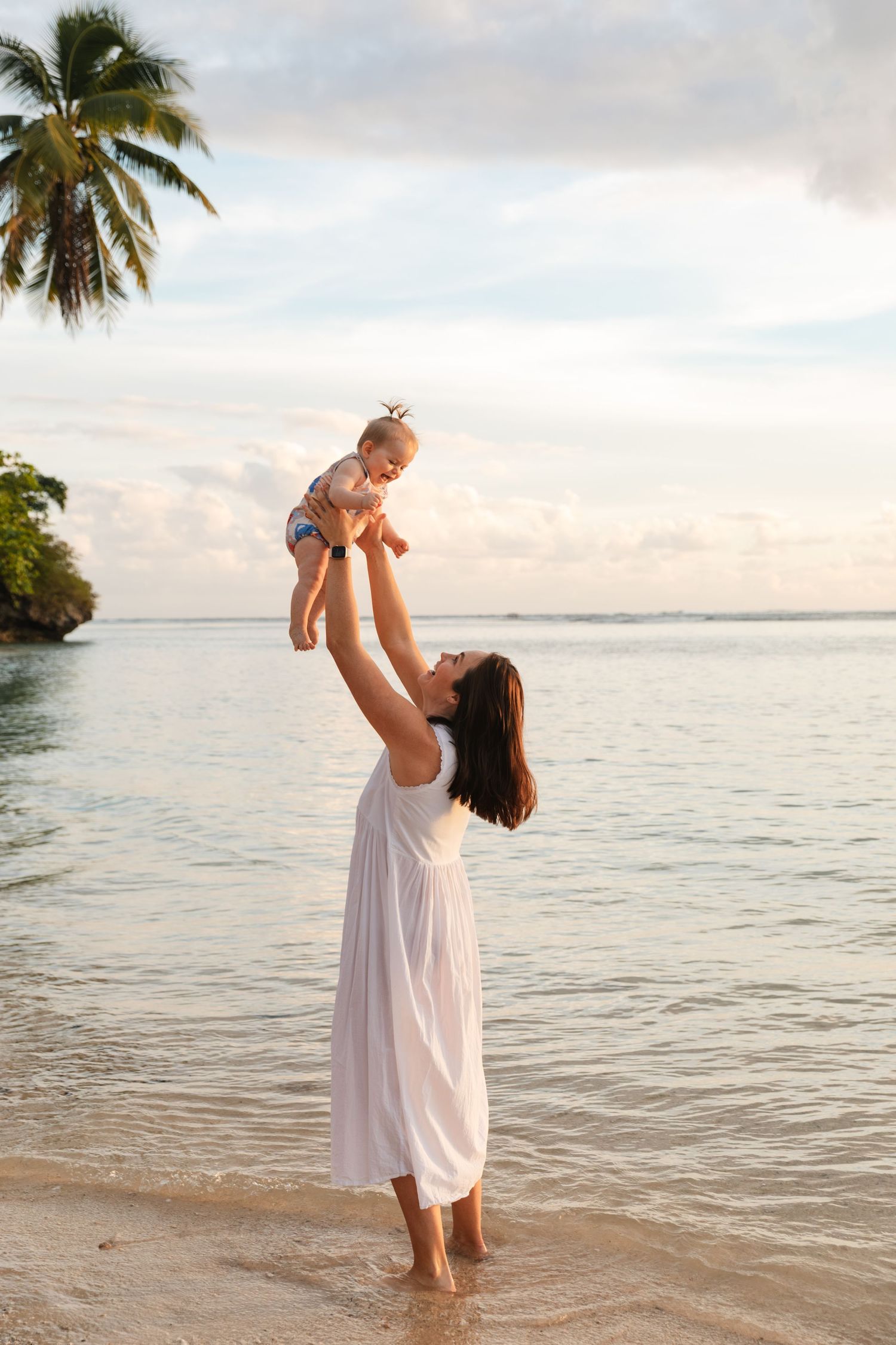Happy mom enjoying a Fiji beach photography session in Fiji with kid